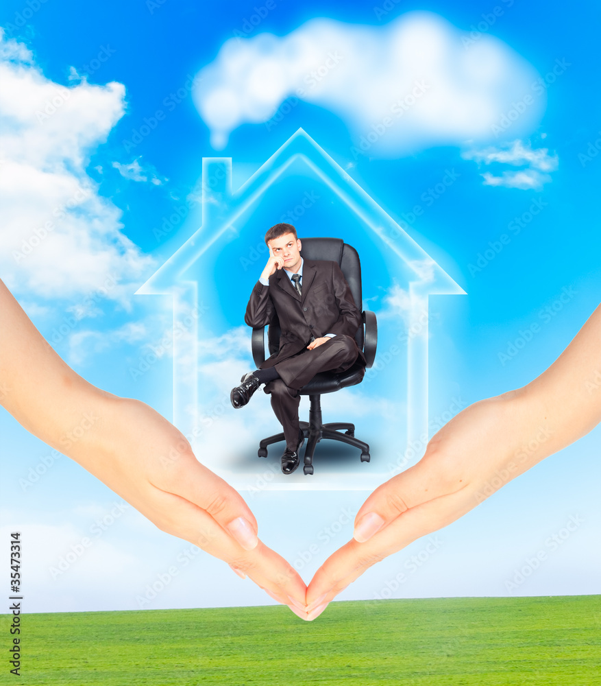 Hands holding model of a house with businessman Hands holding model of a house with businessman