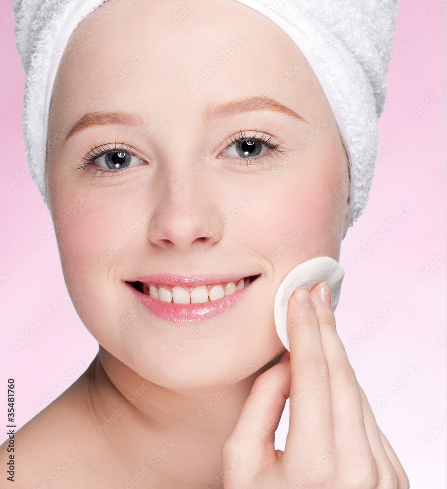 Close-up face of young woman applying sponge Close-up face of young woman applying sponge