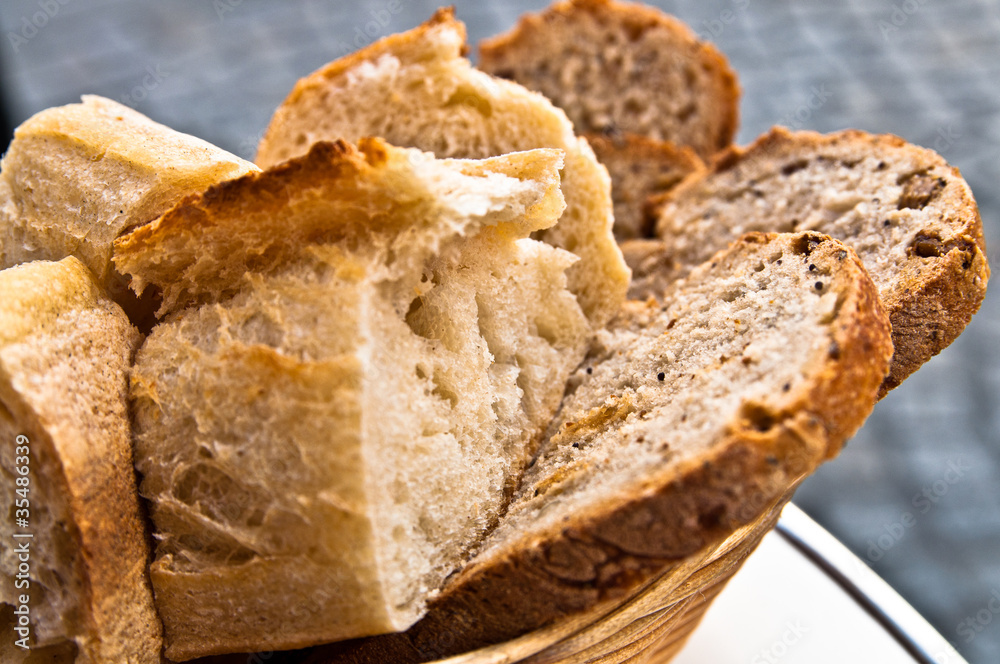 Fototapeta premium bread in basket - little roll breads in basket on table