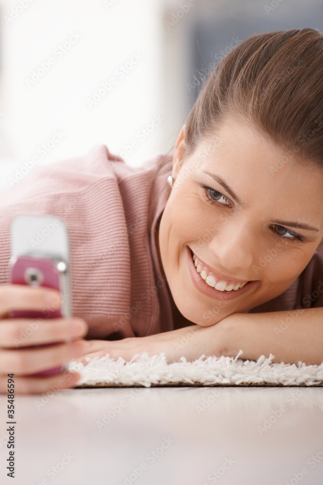 Portrait of happy woman with mobile phone