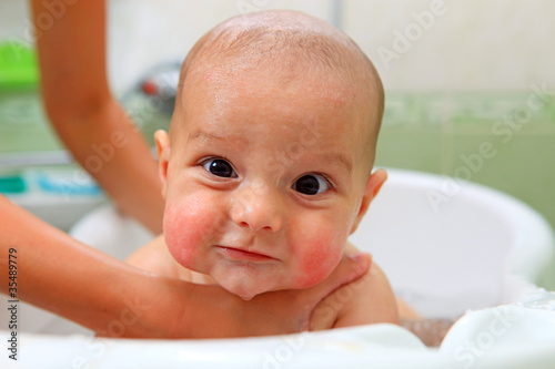 Cute baby boy taking bath
