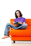 Student reading the book on sofa
