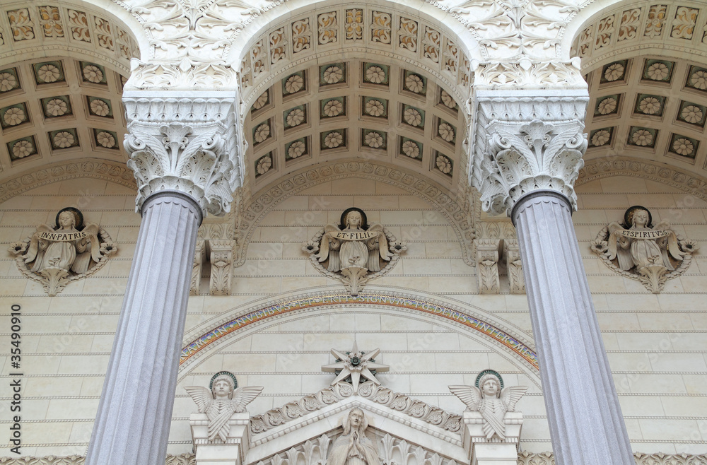 Three sculpted angels adorn the facade of this basilica.