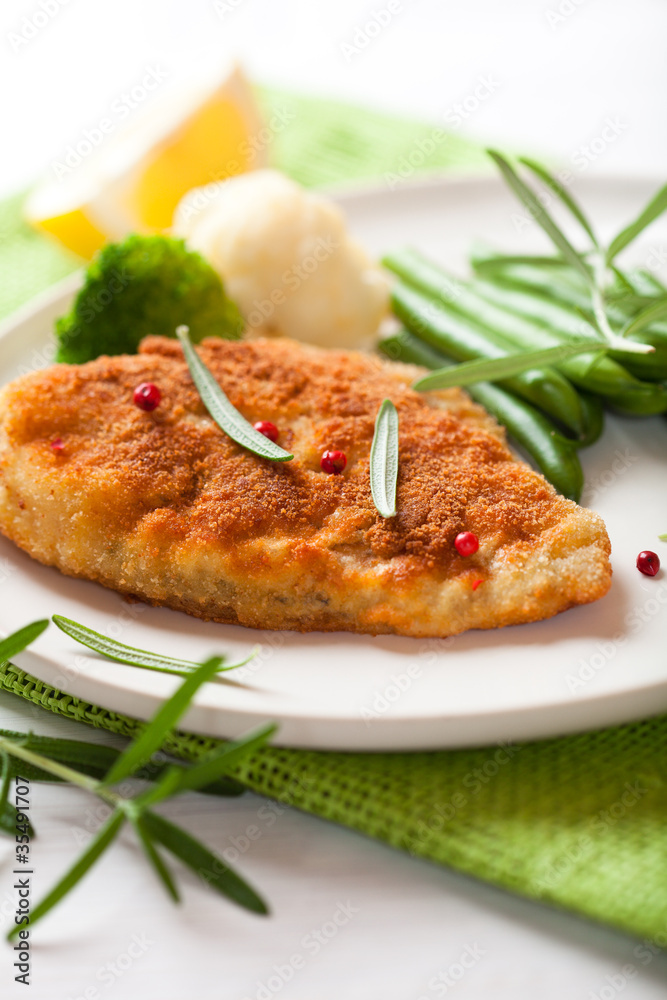 Breaded turbot  fillet with french beans and rosemary