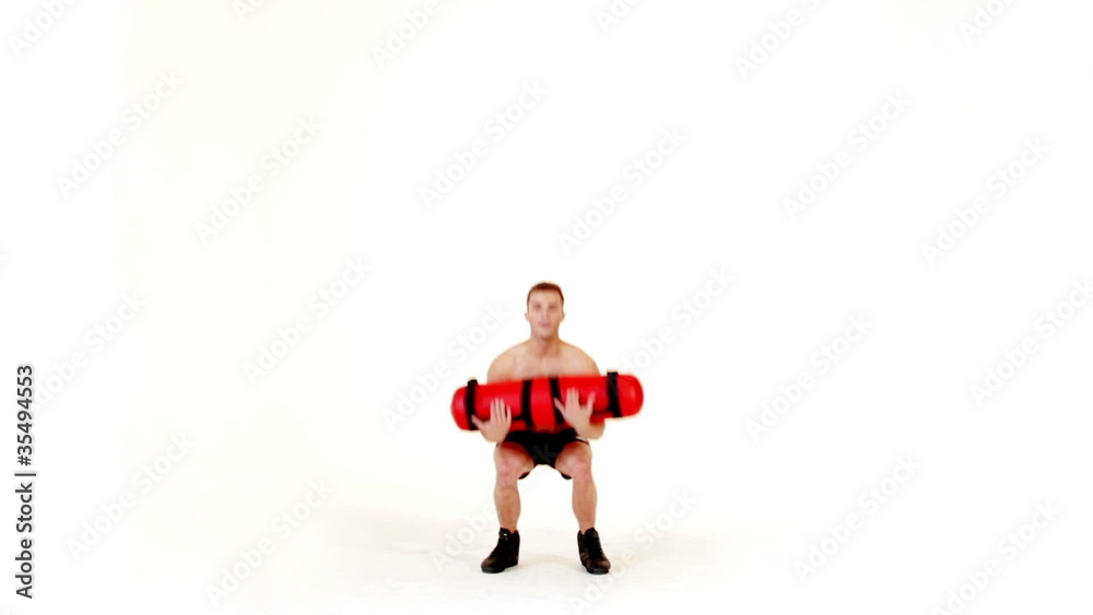 Handsome muscular man exercising with water bag on white Handsome muscular man exercising with water bag on white