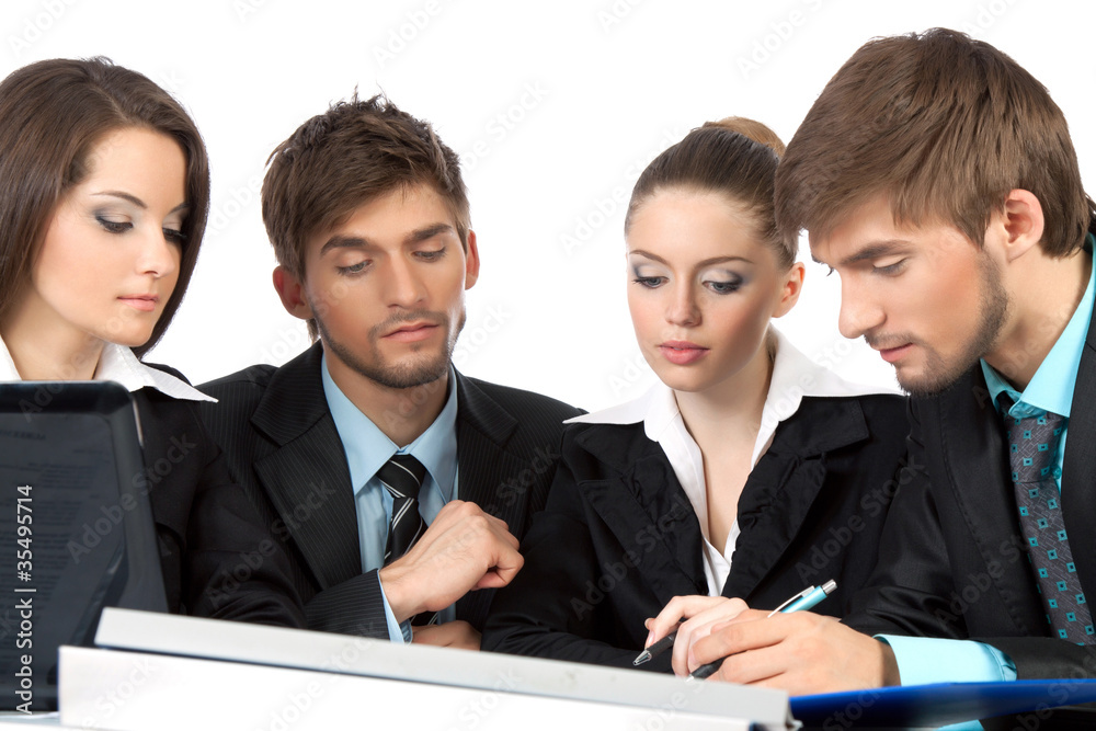 young business people in elegant suits sitting at desk young business people in elegant suits sitting at desk
