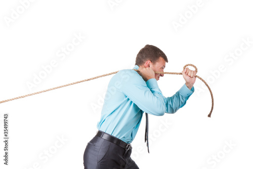 Businessman pulling a rope isolated on white