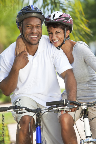 Happy African Man & Woman Couple Riding Bike Smiling