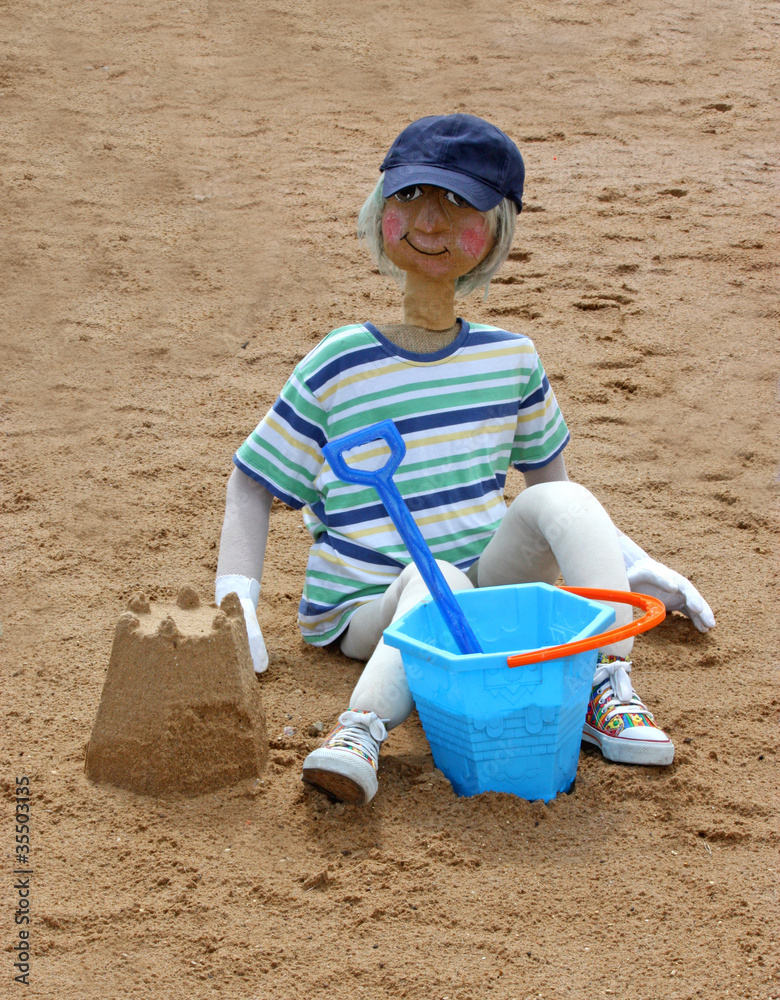 A Scarecrow Figure of a Youngster Playing in the Sand. A Scarecrow Figure of a Youngster Playing in the Sand.