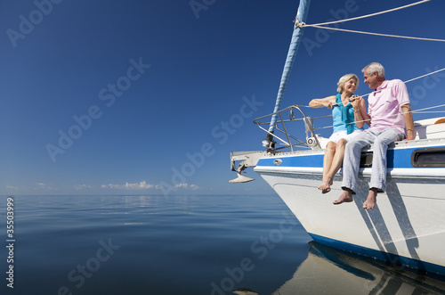 Happy Senior Couple on the Bow of a Sail Boat