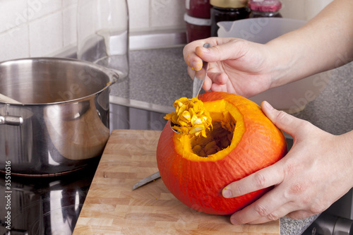 cooking hokkaido pumpkin soup in a modern kitchen. photo