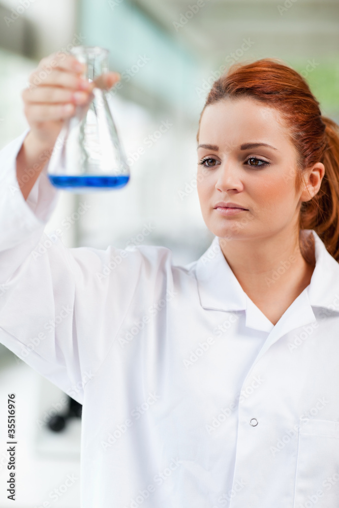 Portrait of a science student looking at a blue liquid Portrait of a science student looking at a blue liquid