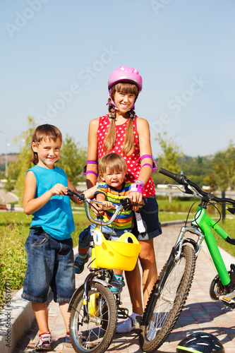 Sister and  brothers with bicycles