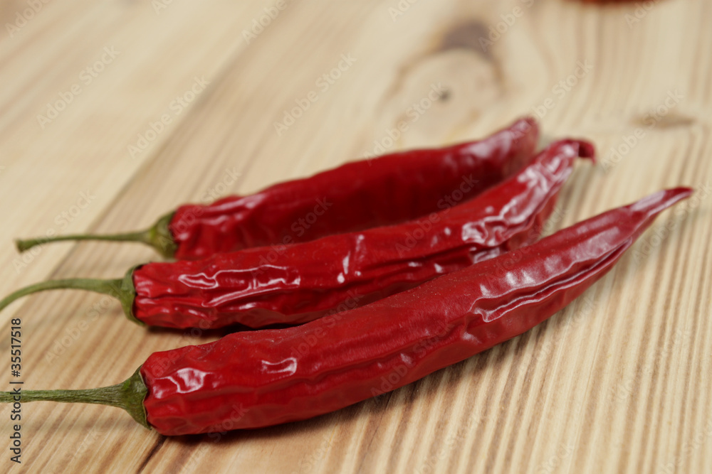 Red chili pepper on wooden table