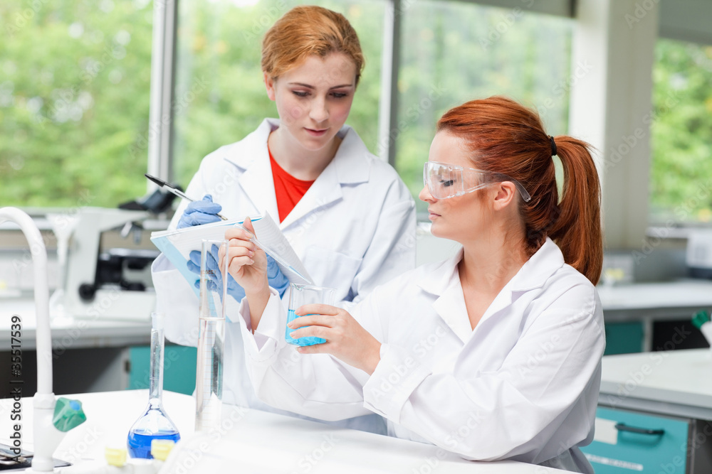 Science students talking about their experiment Science students talking about their experiment