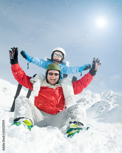Ski, snow, sun and fun - happy family on ski holiday