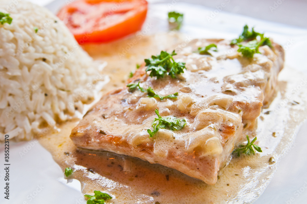 grilled salmon and rice-french cuisine dish with tomato and salm