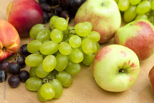 Fresh fruits  apples  grapes and peaches on the table