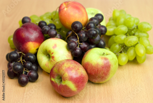 Fresh fruits  apples  grapes and peaches on the table