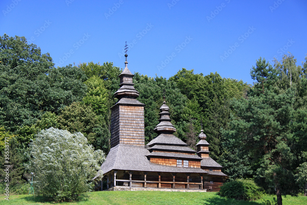 Wooden church in forest.