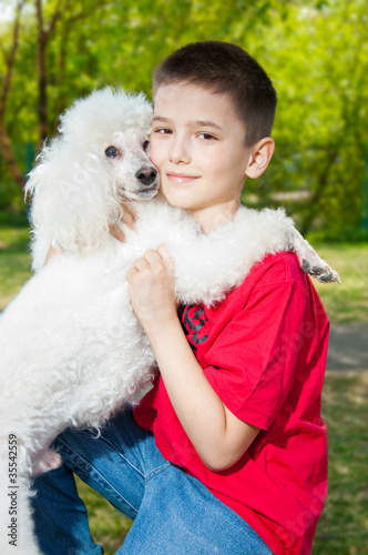 A boy hugs his dog