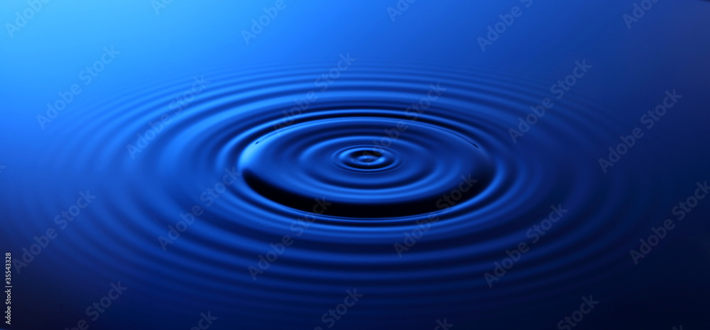 Drop of water falling into the water Drop of water falling into the water
