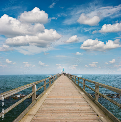 wooden jetty over sea. turquoise water and blue sky