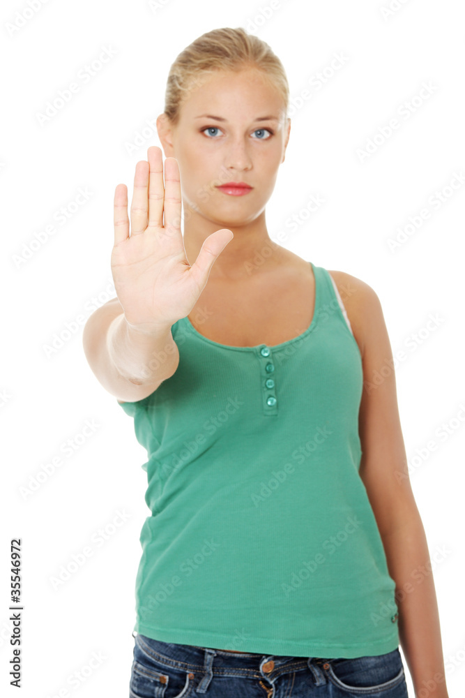 Fototapeta premium Young woman making stop gesture.