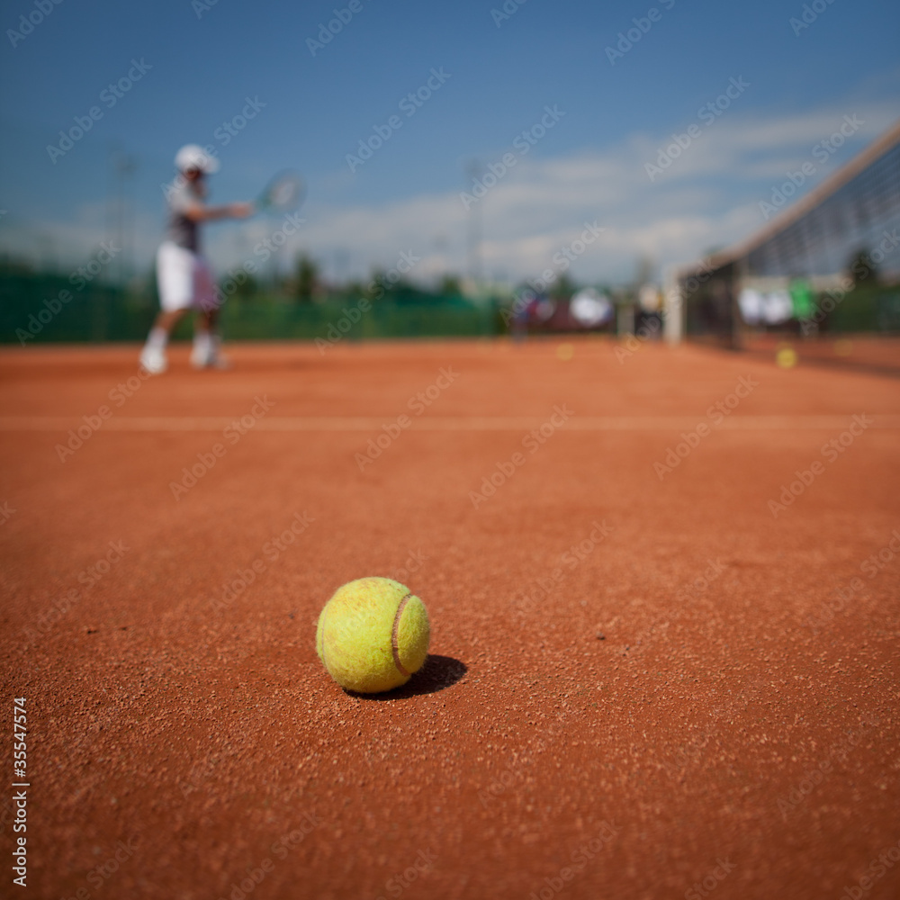 Tennis player in action on tennis court