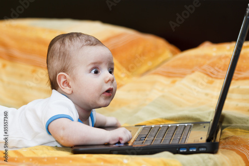 Baby boy with a laptop. argb color profile photo