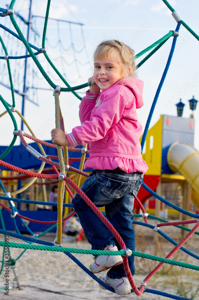 Cheerful little girl on the playground. Cheerful little girl on the playground.