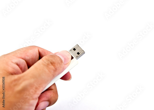 Hand holding USB storage drive.