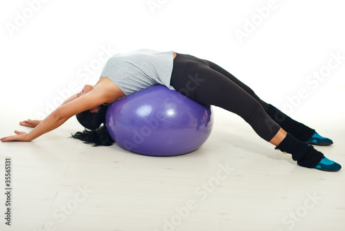 Woman lying on pilates ball
