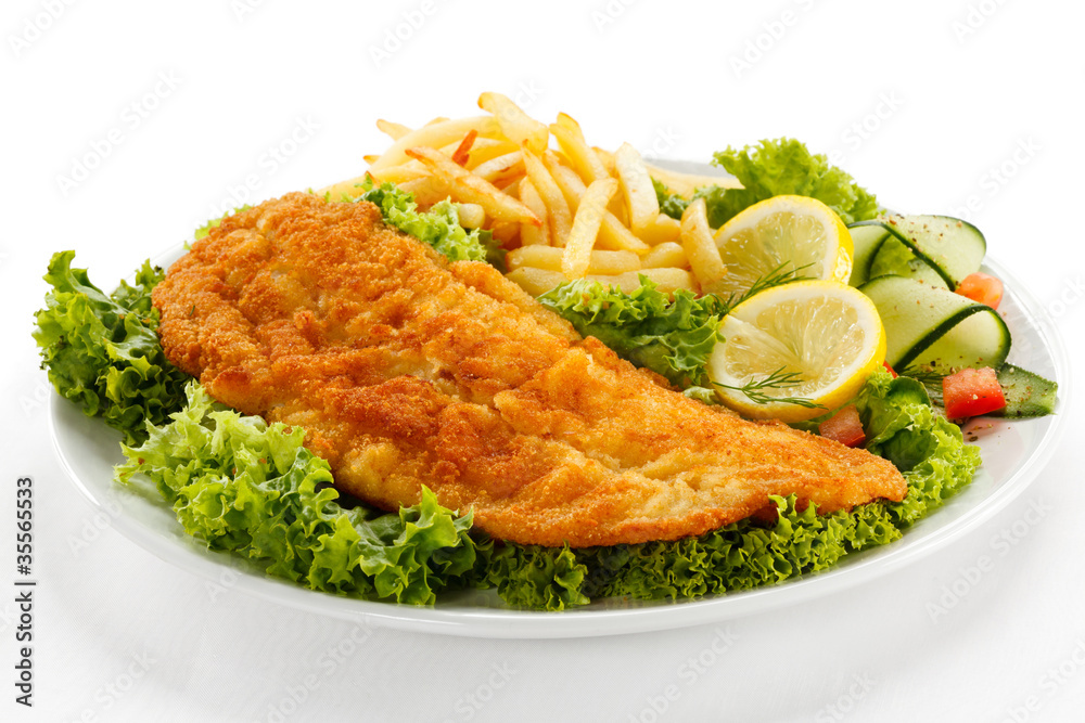 Fish dish - fried fish fillet, French fries with vegetables Fish dish - fried fish fillet, French fries with vegetables