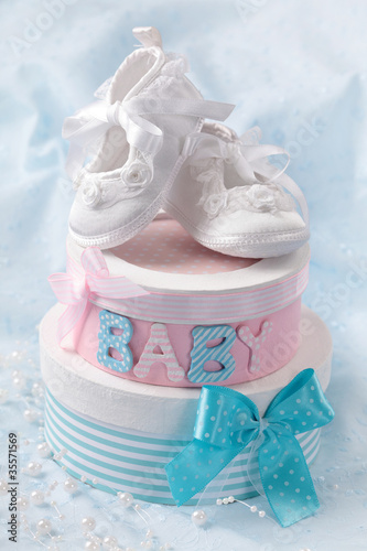 Little baby booties and gift boxes photo