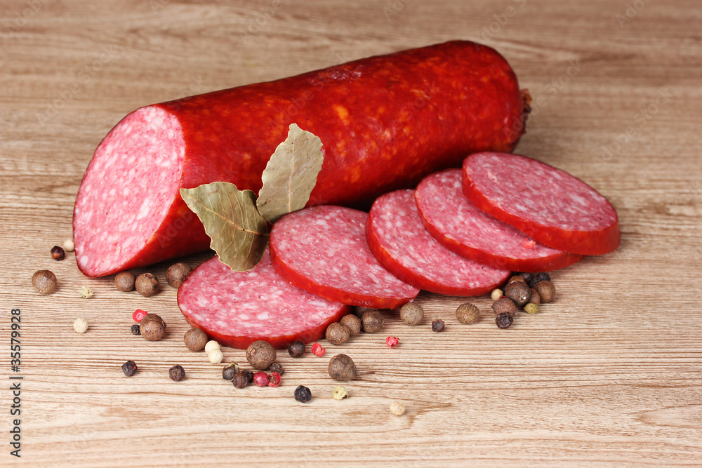 Tasty sausage and spices on wooden background Tasty sausage and spices on wooden background
