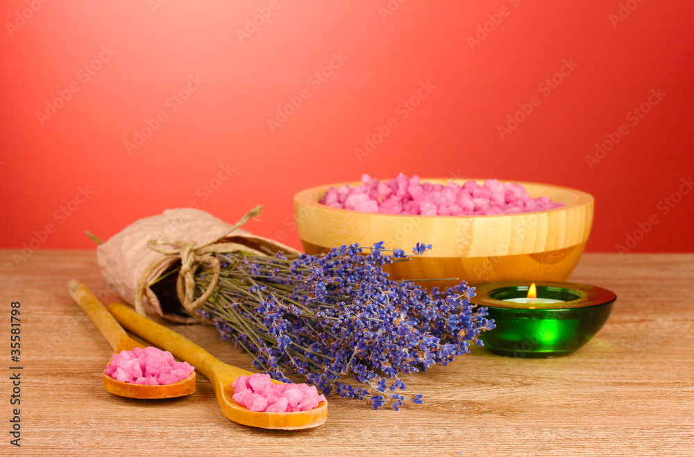 Beautiful lavender, salt and towels on a red background