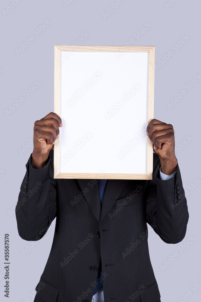 african businessman holding a whiteboard african businessman holding a whiteboard