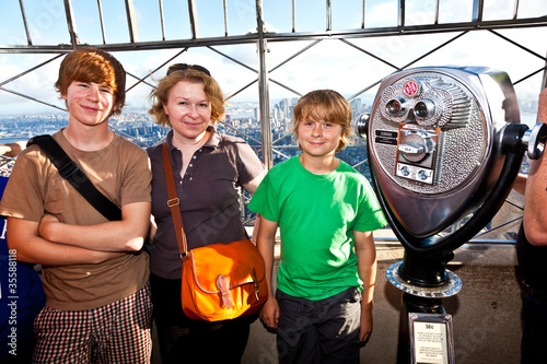 family on platform of Empire State building enjoys the vacation