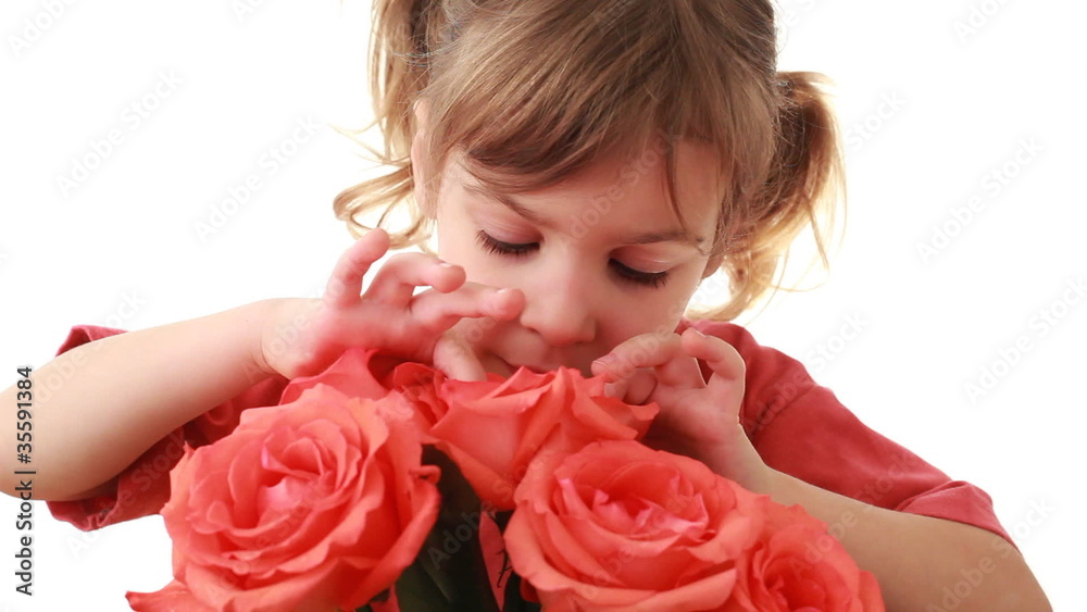 Nice little girl looks inside pink rose in beautiful bouquet Nice little girl looks inside pink rose in beautiful bouquet