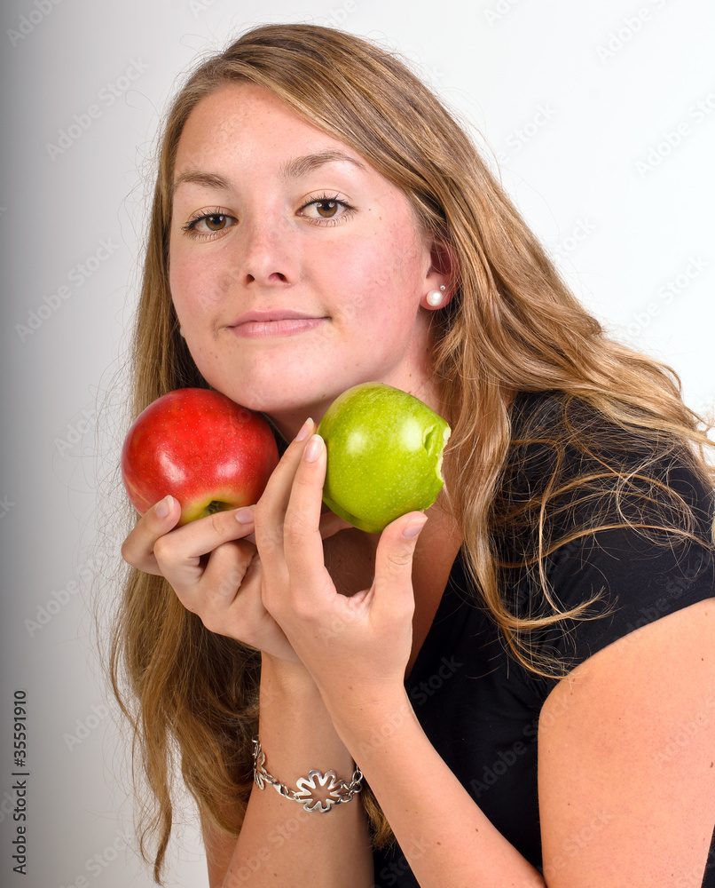 Young fit woman with red and green apple Young fit woman with red and green apple