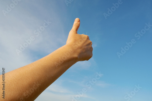 Woman's hand on blue sky