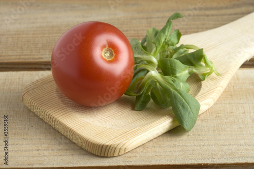 Tomatoe in a wooden spoon