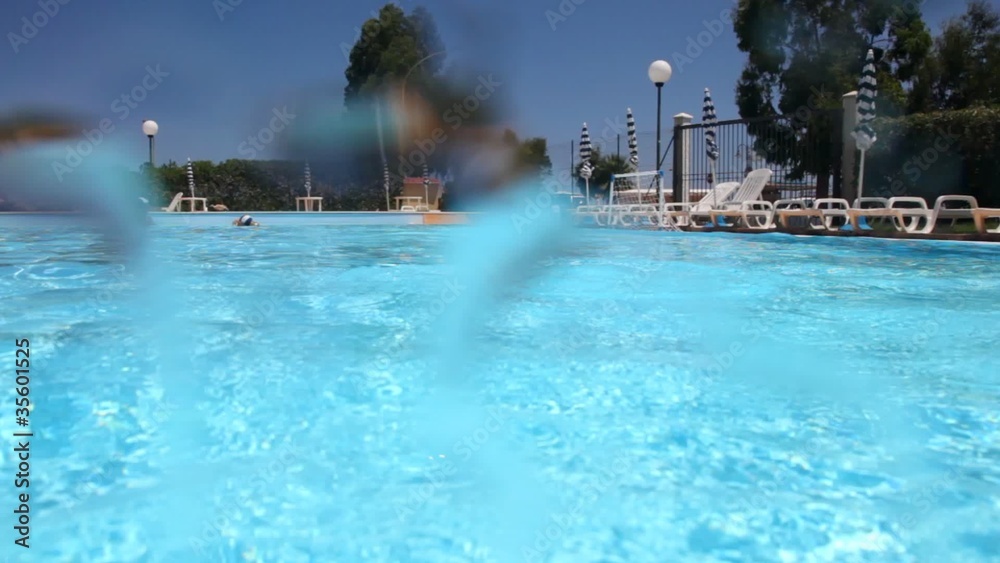 Boy jumped into the pool and threw the ball Boy jumped into the pool and threw the ball