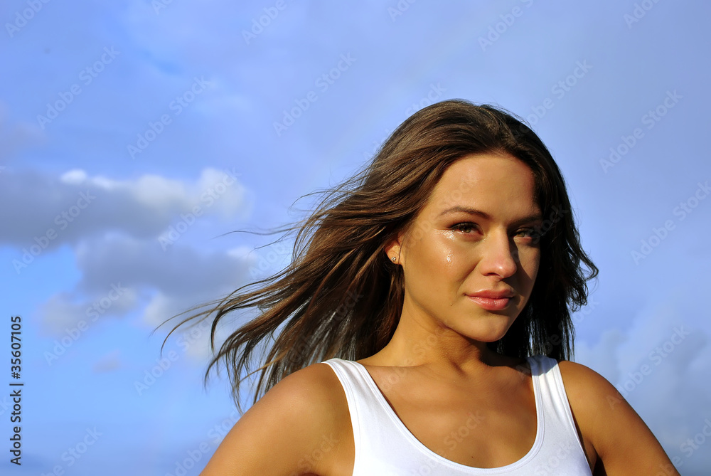 she cries. portrait on the sky background. space for text she cries. portrait on the sky background. space for text