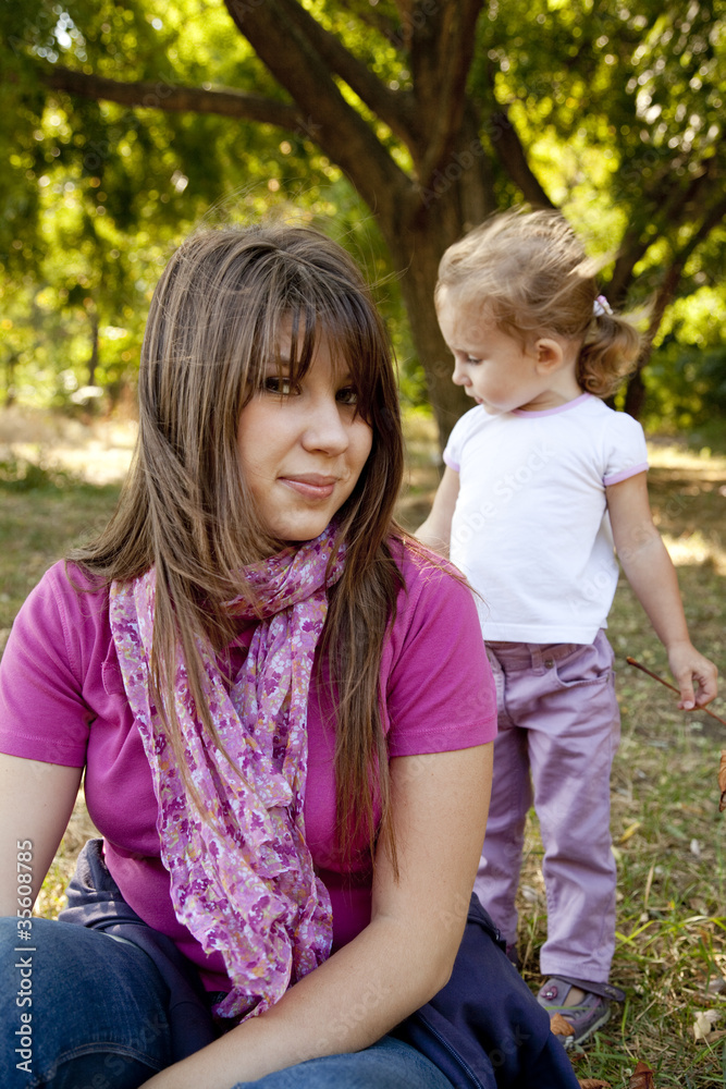 Little girl and mother in the park Little girl and mother in the park