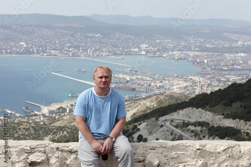 Man poses on Tsemess Bay background photo