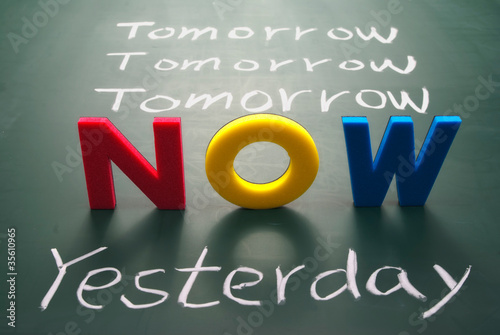 Now, yesterday, and tomorrow words on blackboard