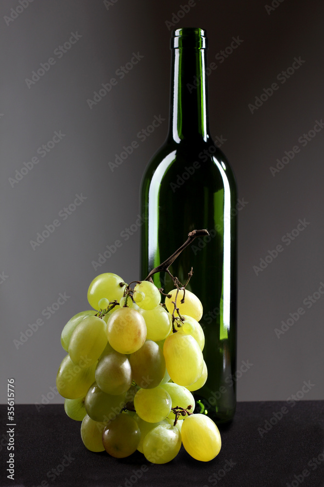 Winebottle and grapes
