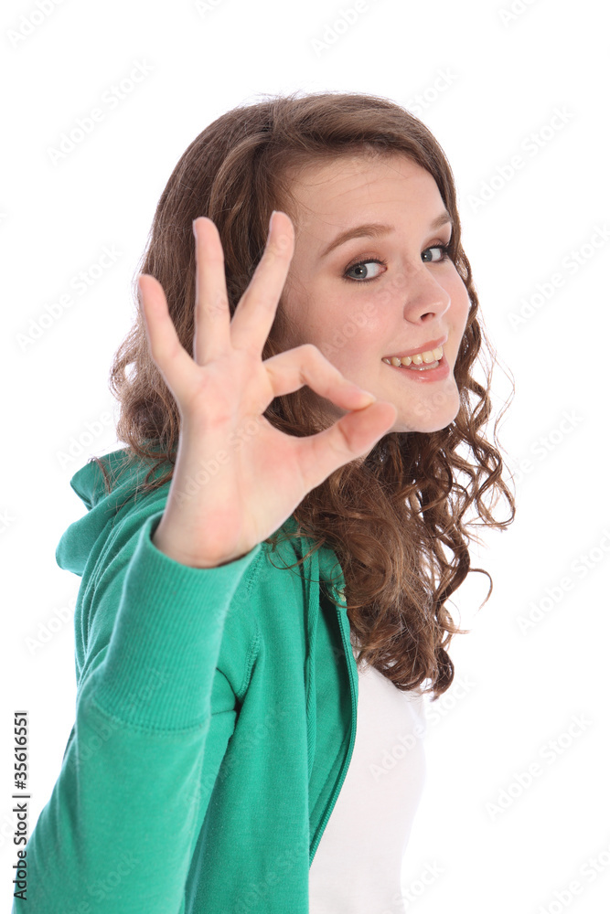 Okay hand sign success by smiling teenager girl